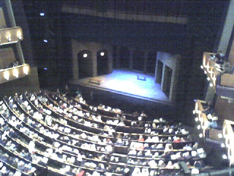 View from high in the Ahmanson Theatre balcony looking down over the full audience to the lit stage