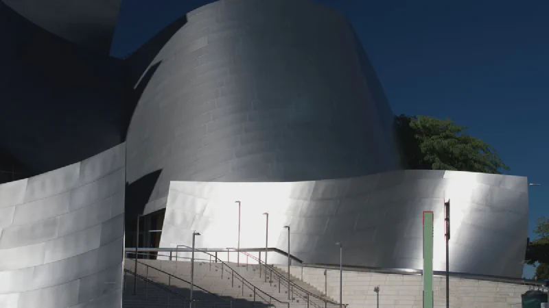 The silver curved exterior of Walt Disney Concert Hall on Bunker Hill in downtown Los Angeles