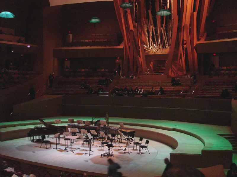 The stage and pipe organ at Walt Disney Concert Hall with terraced wooden seating wrapping around and behind it